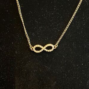 Handcrafted gold tone Infiniti charm on 20in gold tone chain w/extender